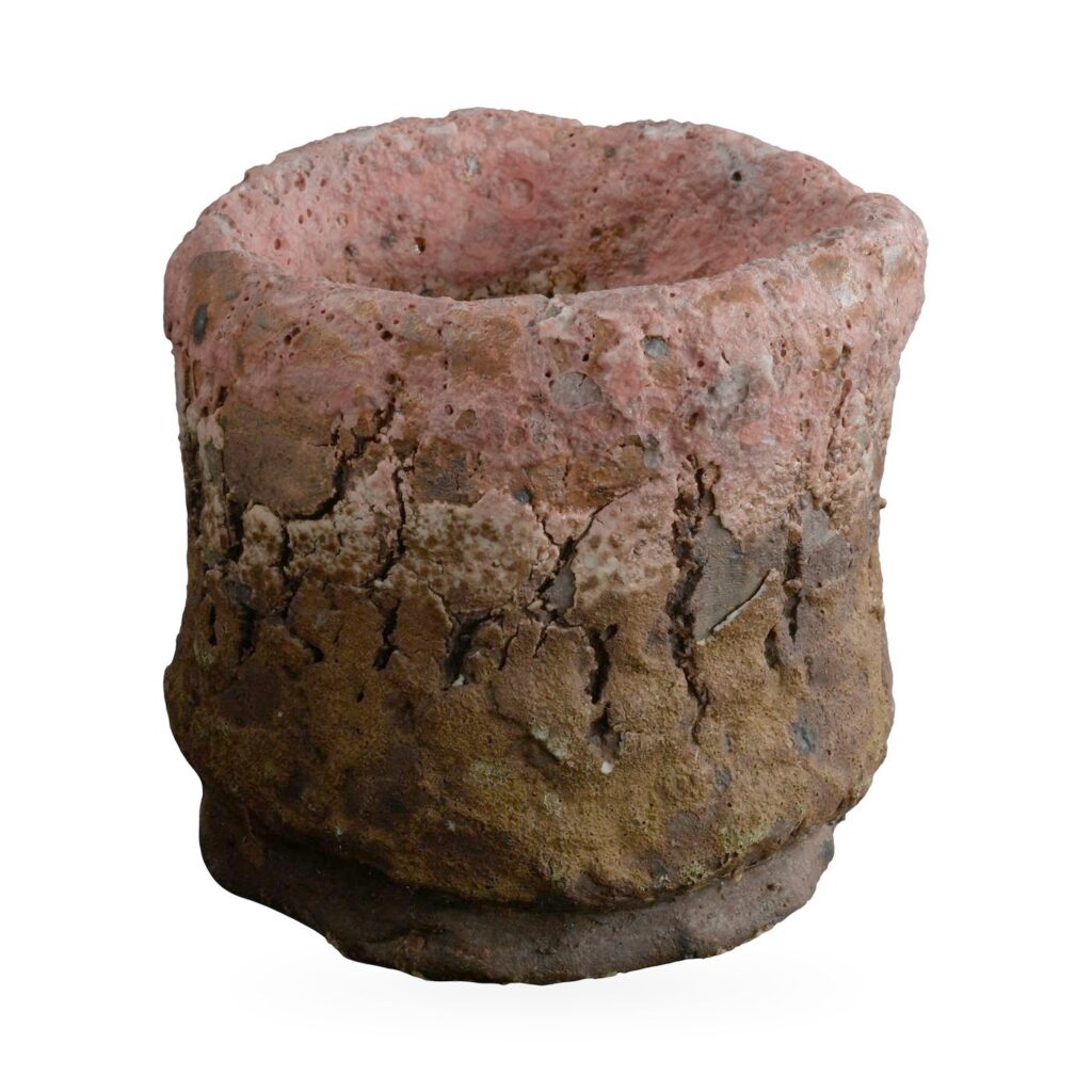 Rough stone-texture cylinder pot fading from dusty pink at the rim to ochre-brown at the base