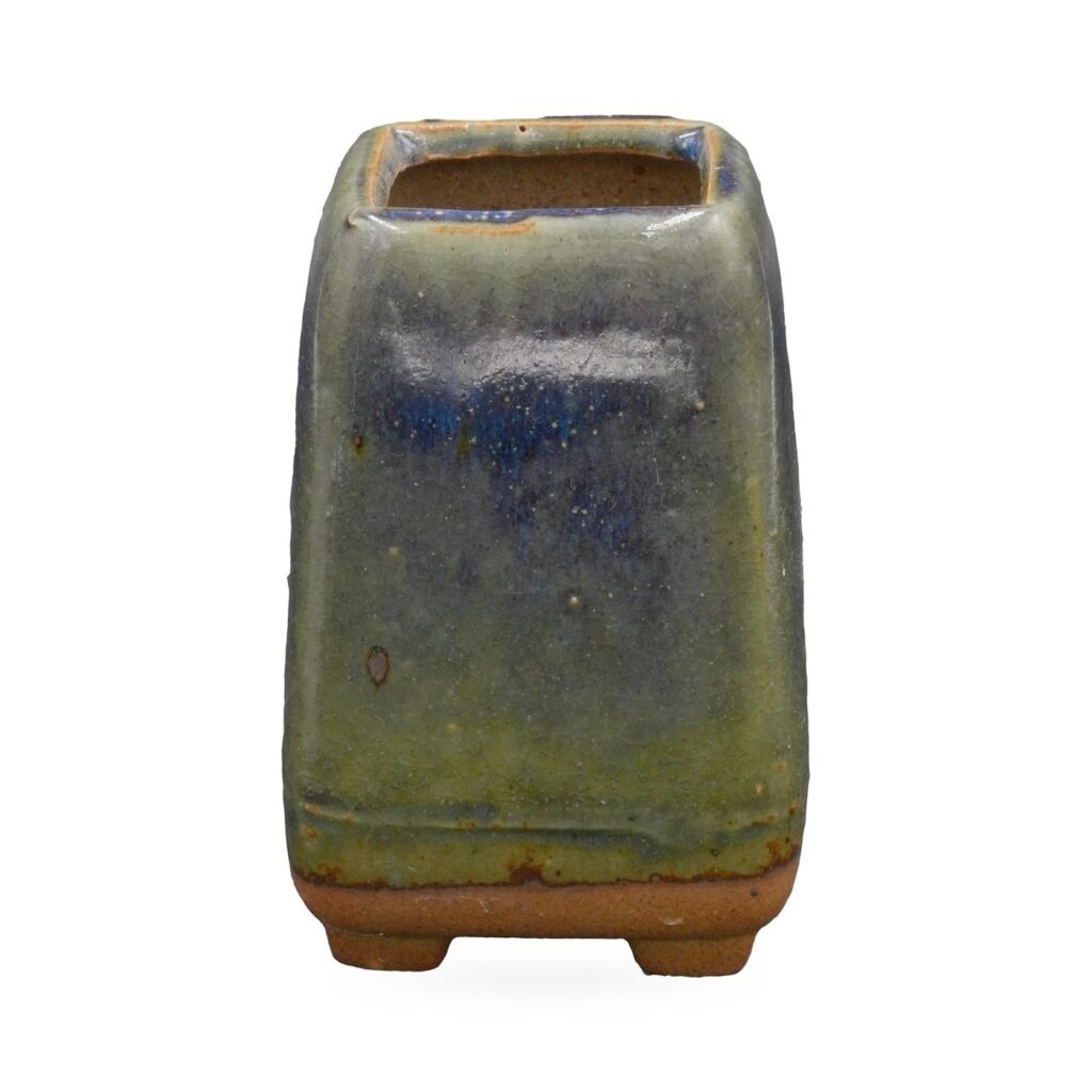 Tall square succulent pot in glossy olive-green and cobalt-blue glaze, standing on small feet