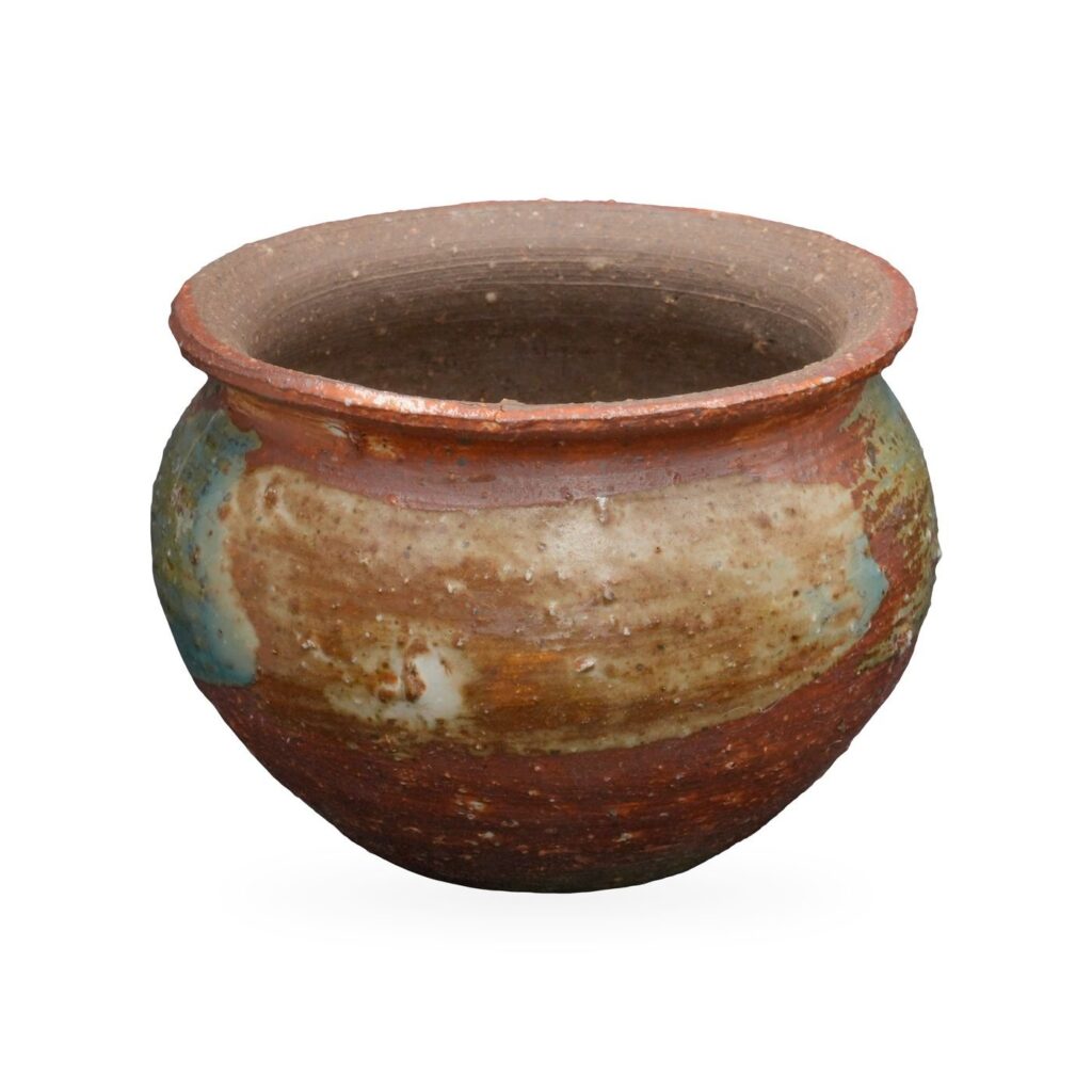 Round rust-red glazed pot with flared rim and a cream, teal and sage-green glaze band