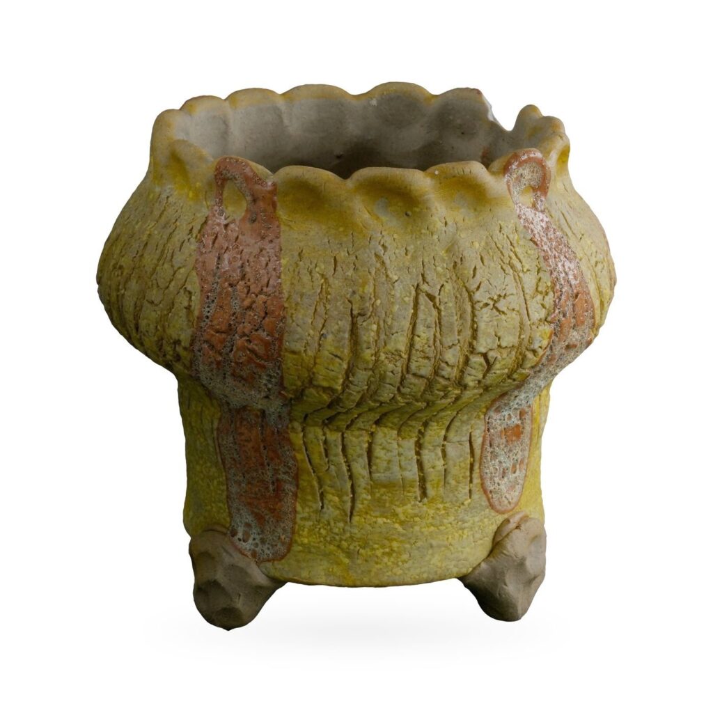 Mustard-yellow crackle-glaze footed pot with rust-orange stripes and a scalloped rim