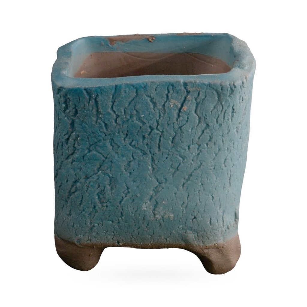 Square teal crackle-textured succulent pot with softly irregular corners and chunky brown clay feet