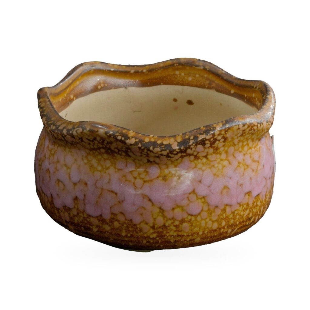 Low wavy-rim pot with glossy pink speckles over amber and brown glaze