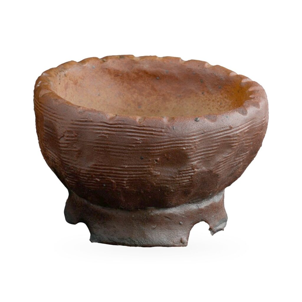 Rustic red-brown glazed bowl pot with crimped rim, ridged sides and notched foot