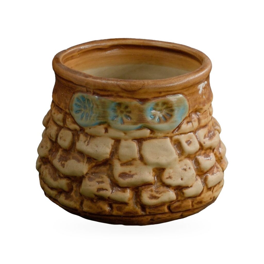 Rounded glazed pot with raised cream-and-brown cobblestone pattern and a blue-green flower band