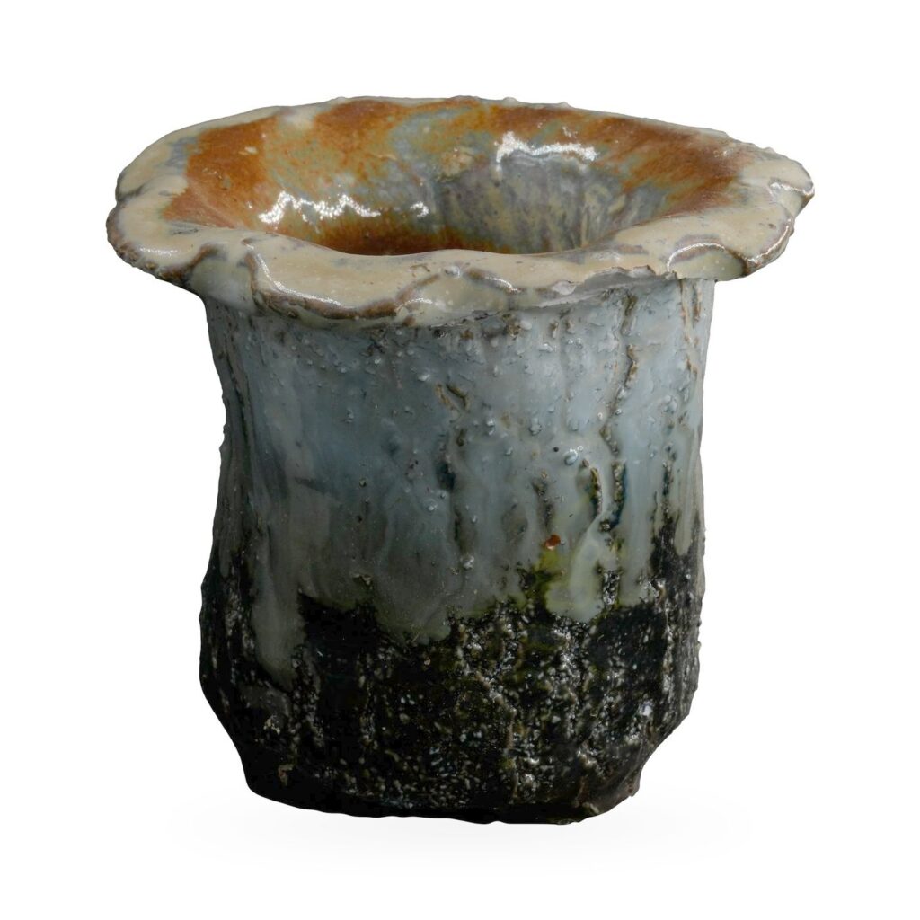 Ruffled-rim succulent pot with cream and blue-grey drip glaze over a textured near-black base