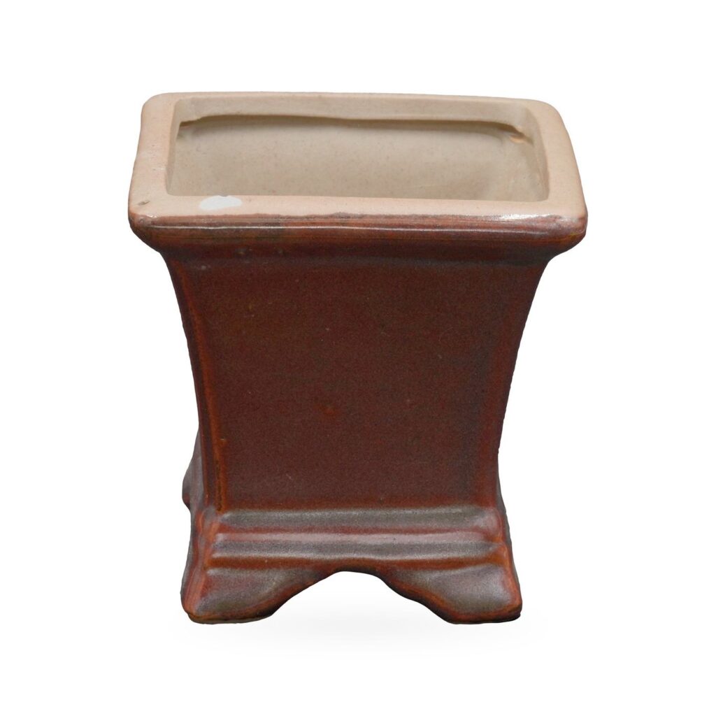 Flared square pot in glossy maroon with buff clay rim, banded base and small shaped feet