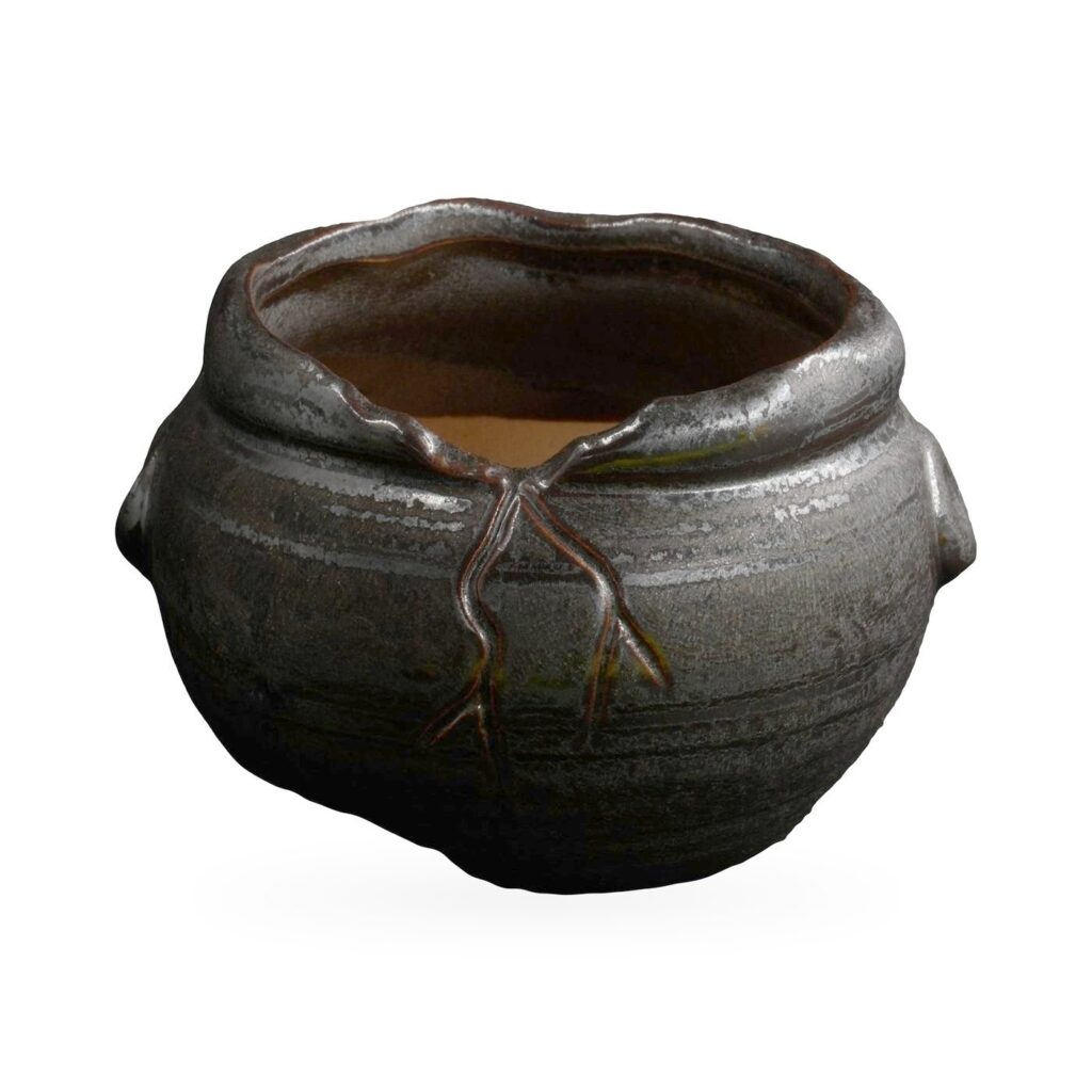 Round glossy black glazed pot with raised brown branch relief and side lug knobs