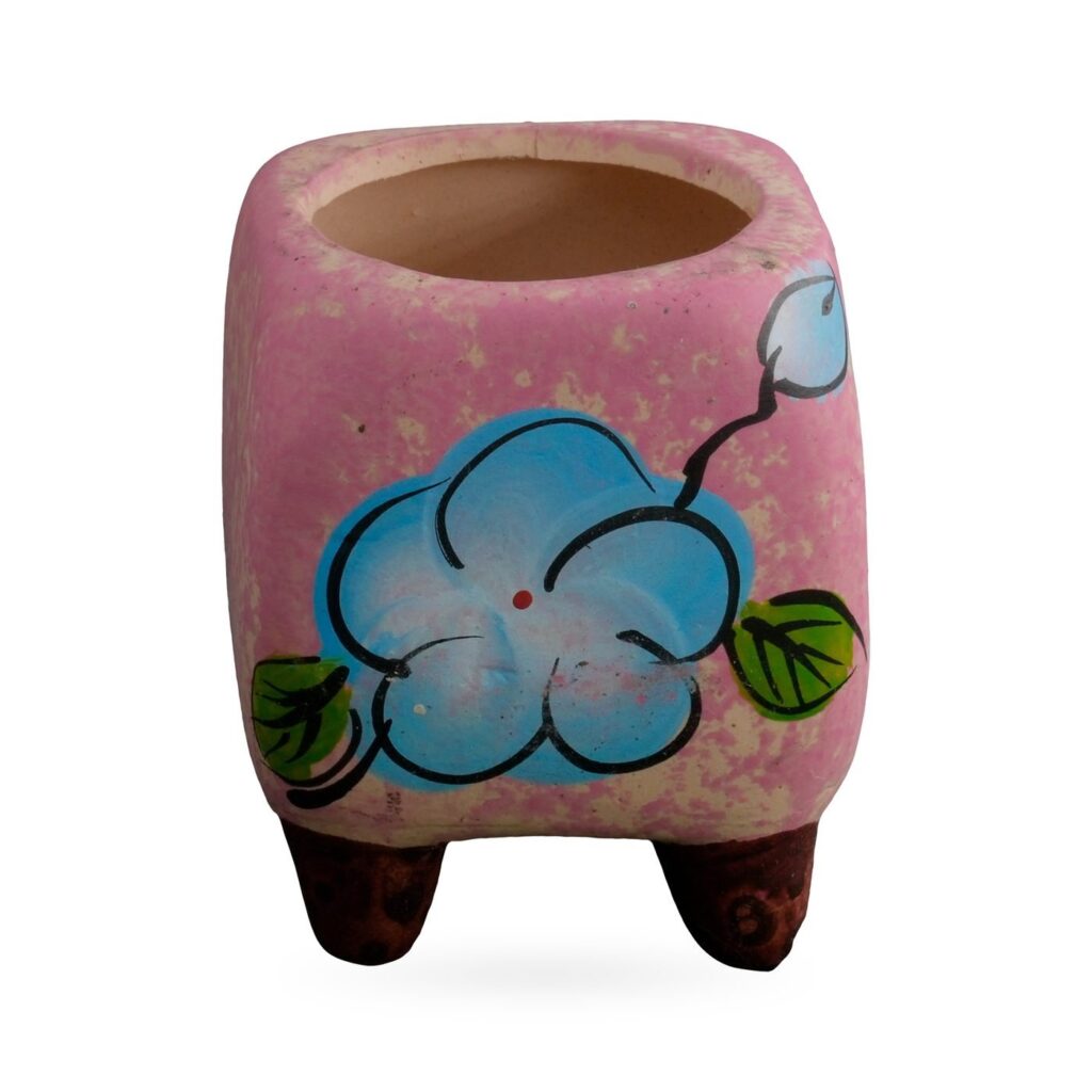 Speckled pink rounded-square footed pot with a painted blue flower, 5.5×6.5cm