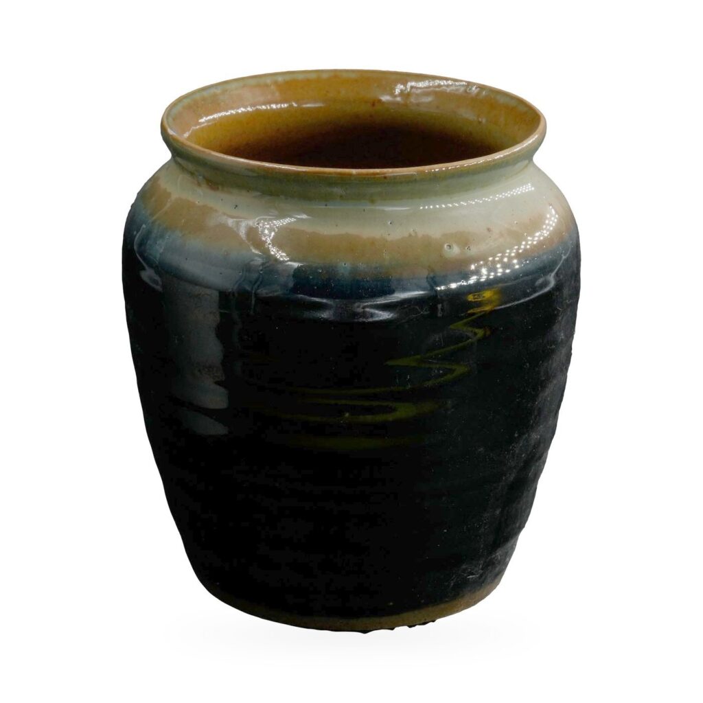 Rounded black glazed jar pot with a pale sage and blue-grey shoulder band and a brown rim