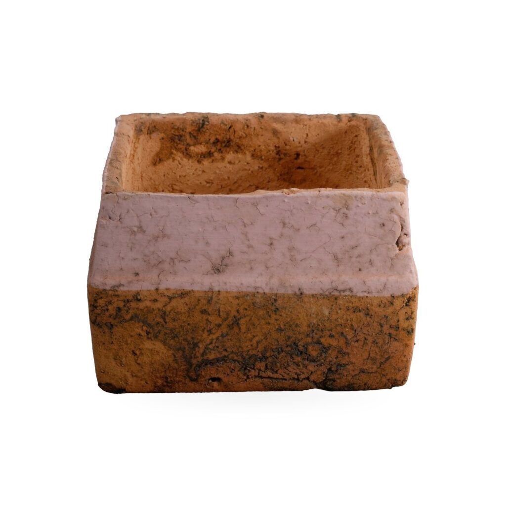 Low orange square pot with dark mottling and a wide soft pink band around the upper sides