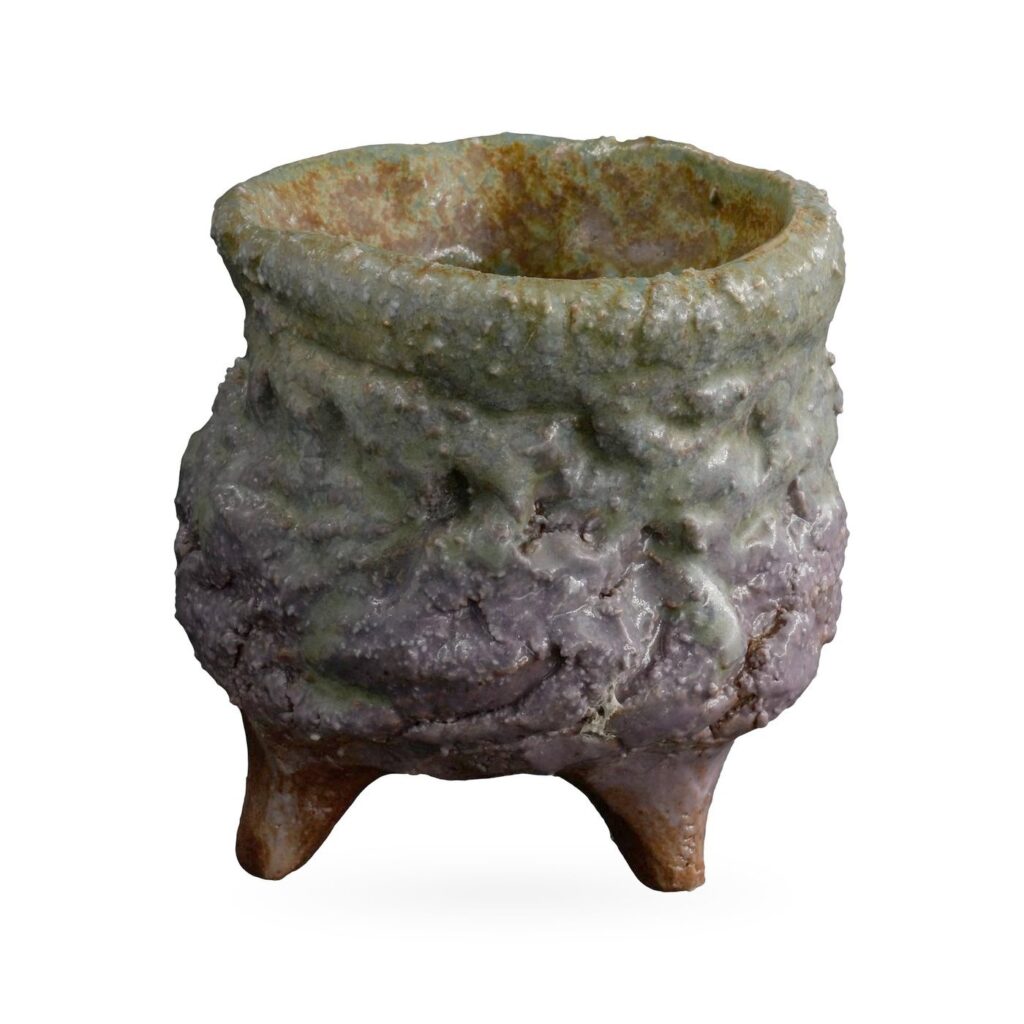 Rough-textured cauldron-style pot in sage green and dusky purple on small clay feet