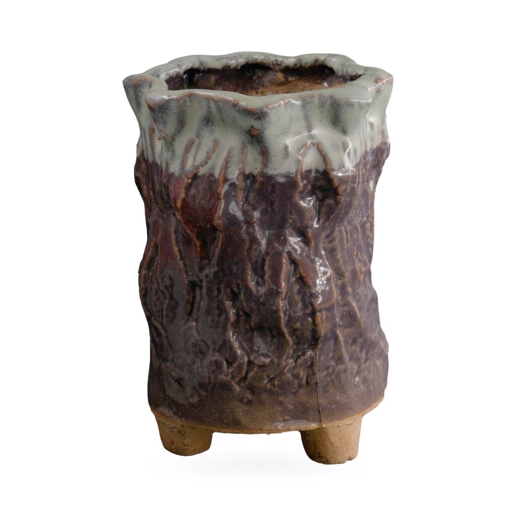 Tall plum-brown bark-textured footed pot with sage green glaze dripping from a wavy rim