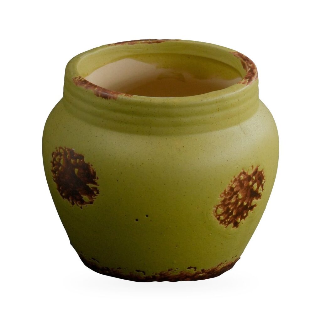 Lime-green matte rustic pot with ribbed collar and rust-brown distressed patches