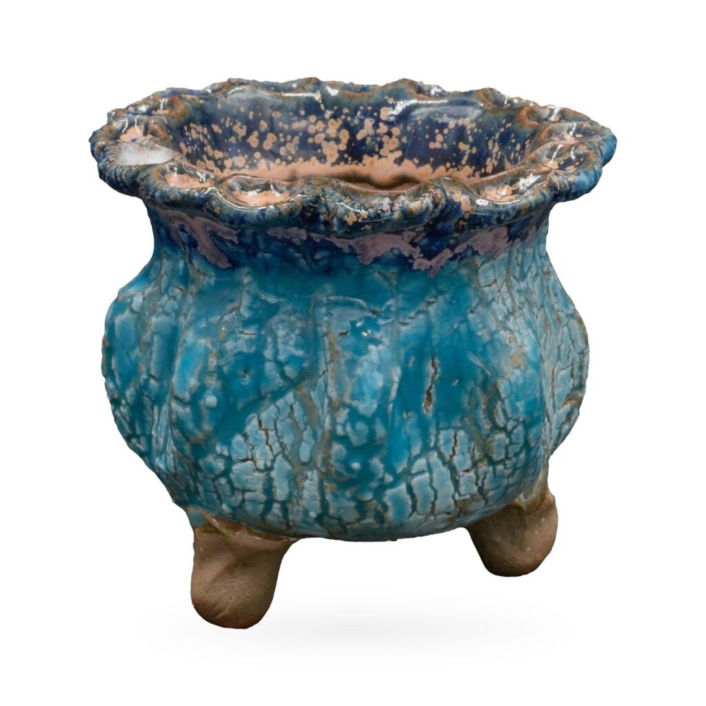 Sky-blue crackle-glaze round pot with navy scalloped rim speckled in peach, on small clay feet