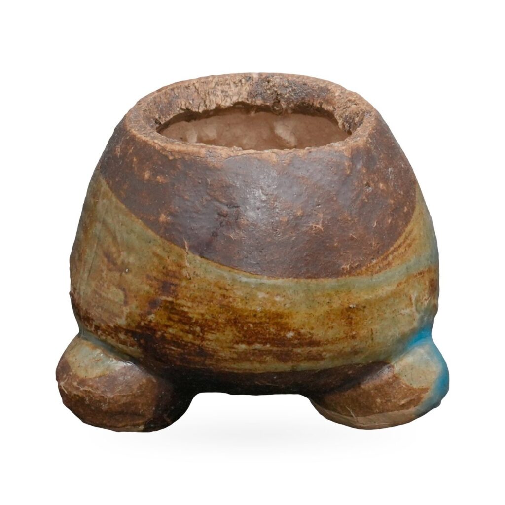 Mini brown coarse-clay pot with sage-green and turquoise glaze band on small rounded feet