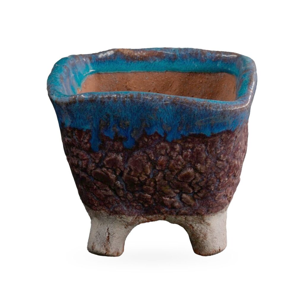Square footed pot with a glossy teal-blue drip rim, textured plum-brown body and pale feet, 10.5×8.5cm