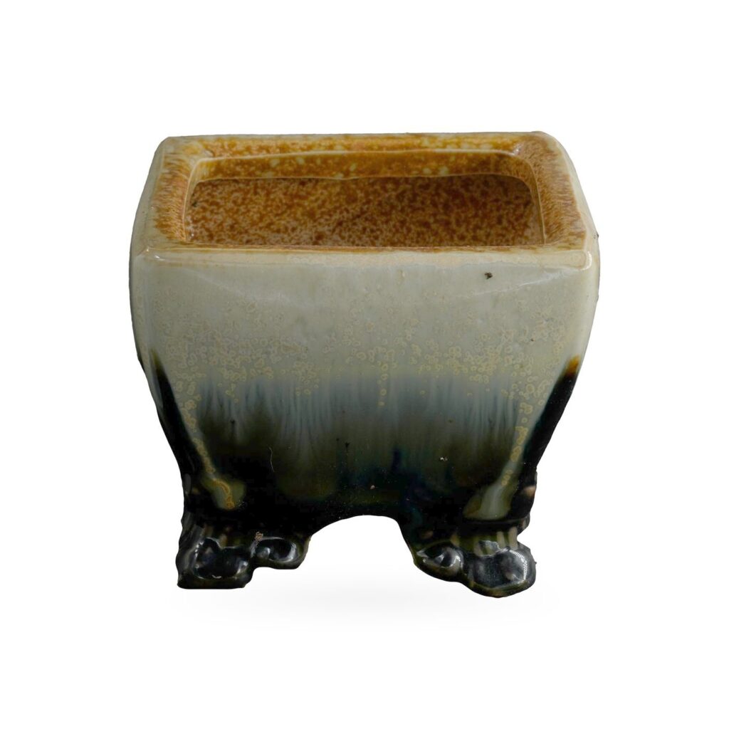 Square pot in cream glaze with black and deep blue drips running down to small black feet