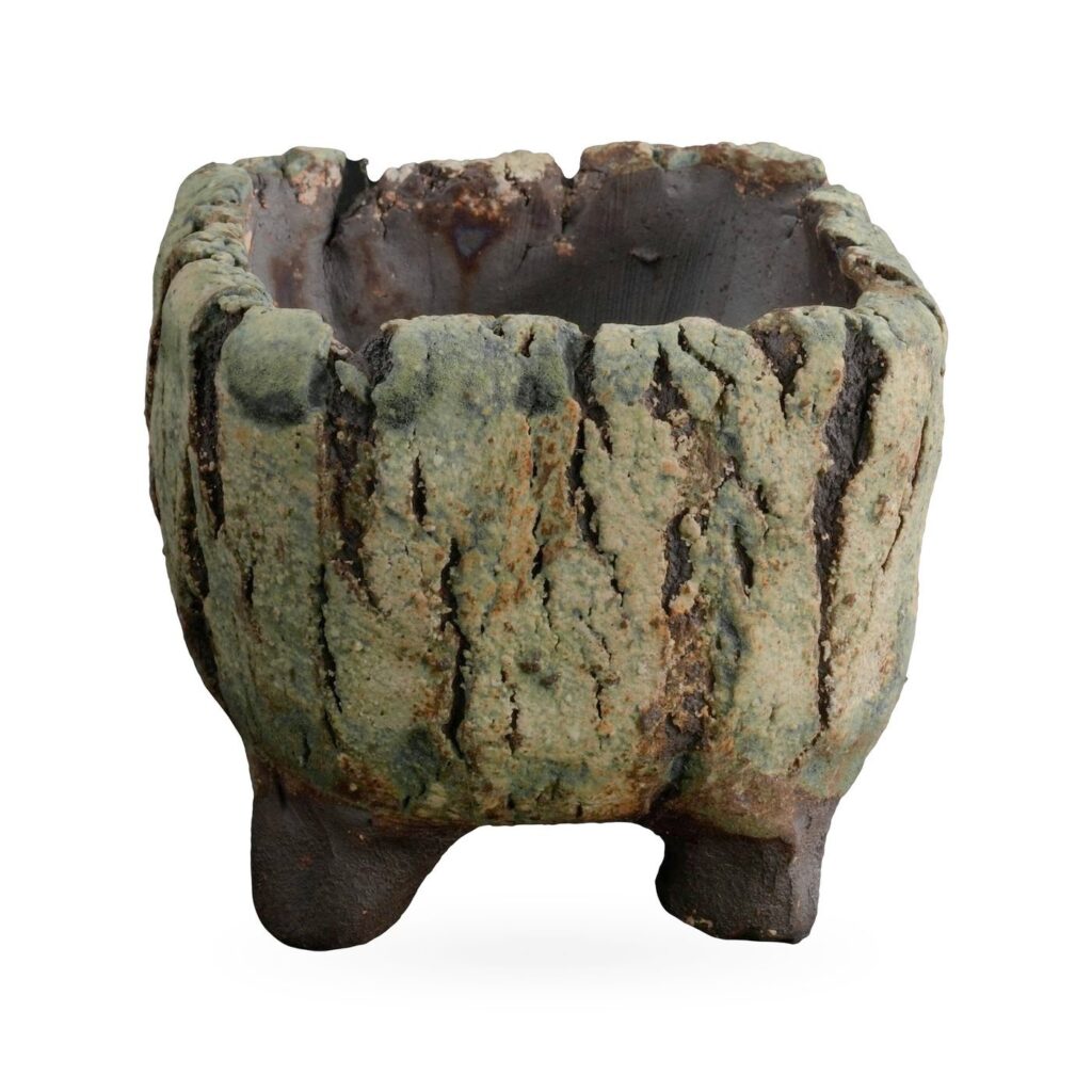 Square footed pot with moss-green bark-like texture, dark fissures and dark brown feet