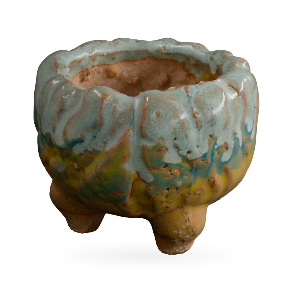 Footed textured pot with pale duck-egg blue drip glaze over ochre-yellow and teal bands