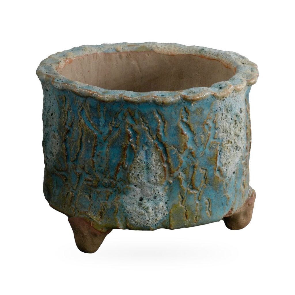 Round turquoise and teal bark-texture footed pot with pale lava-style glaze patches
