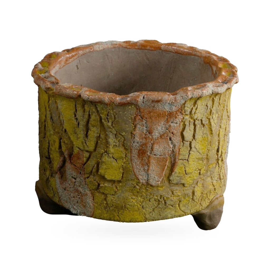 Mustard yellow bark-texture footed pot with rust-orange patches and a scalloped rim