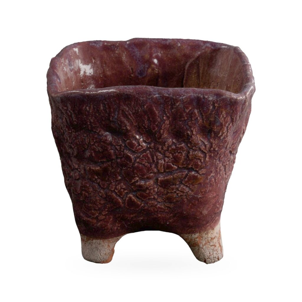 Square maroon textured-glaze pot on pale unglazed feet, 11×10cm