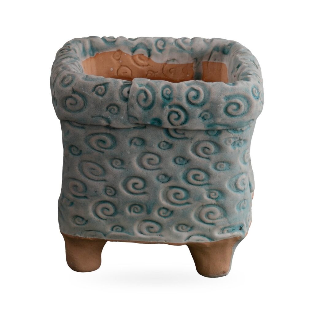 Square footed pot covered in raised swirls with grey-blue and teal glaze and a folded collar rim