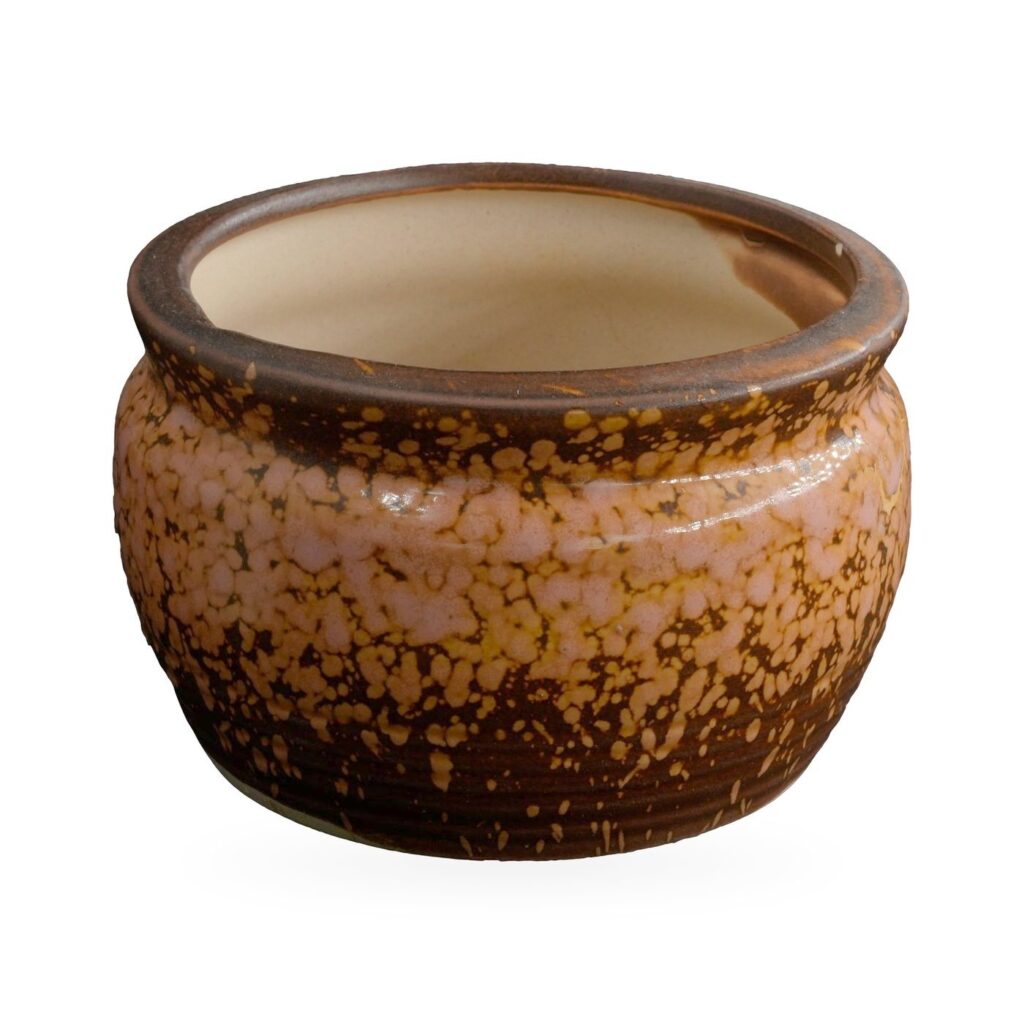 Rounded bowl pot with rolled rim and glossy orange and peach speckles over dark brown