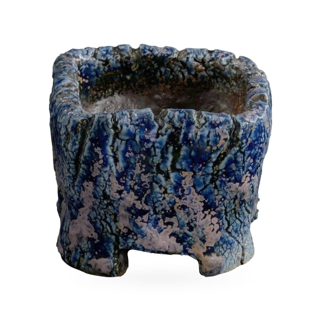 Mini square pot with bark-like texture in speckled cobalt blue and lilac glaze on low feet