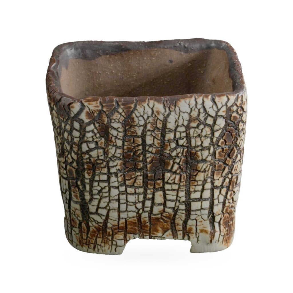 Square pot in cream-white crackle glaze with dark brown bark-like veining and low corner feet