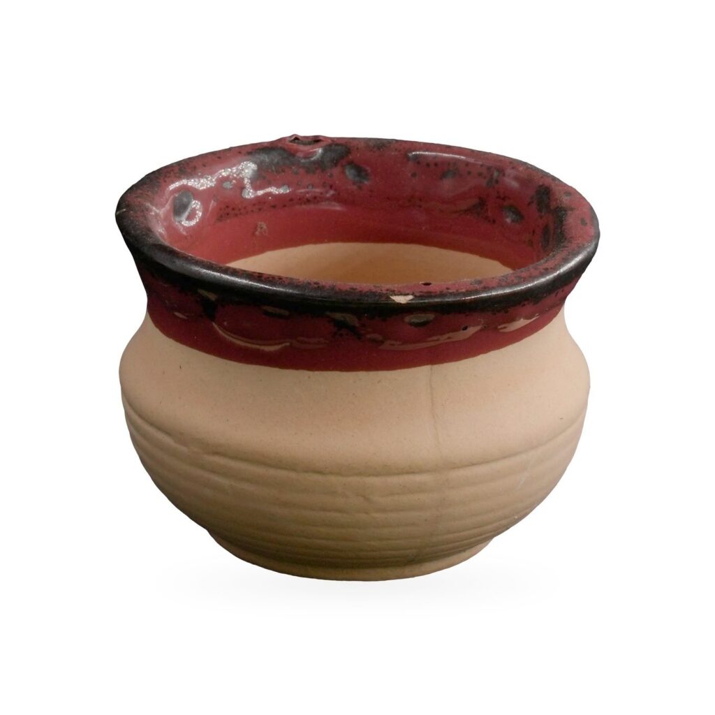 Small sand-coloured ribbed clay bowl pot with a glossy red and black glazed rim