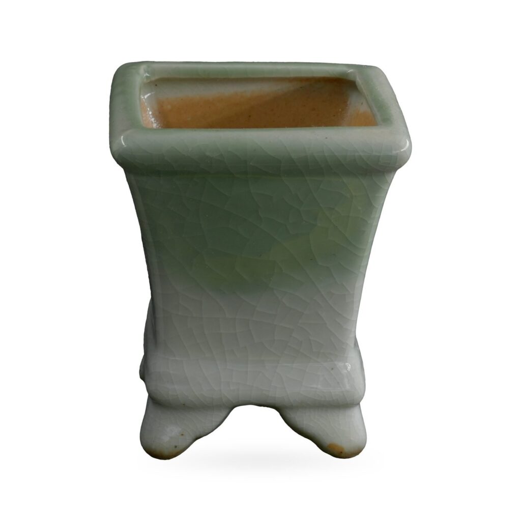 Square footed pot in celadon green crackle glaze fading to white near the base