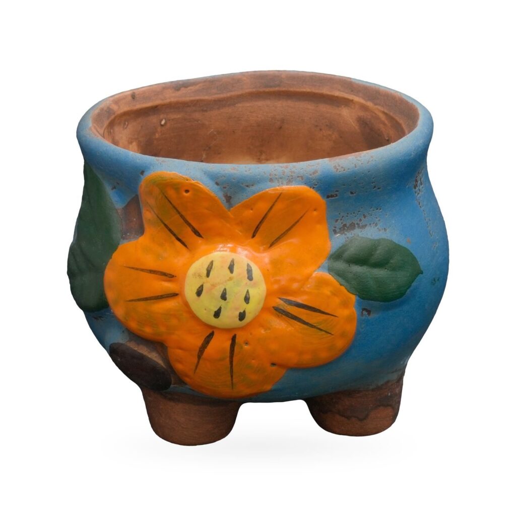 Blue painted terracotta footed pot with a raised orange flower and green leaves