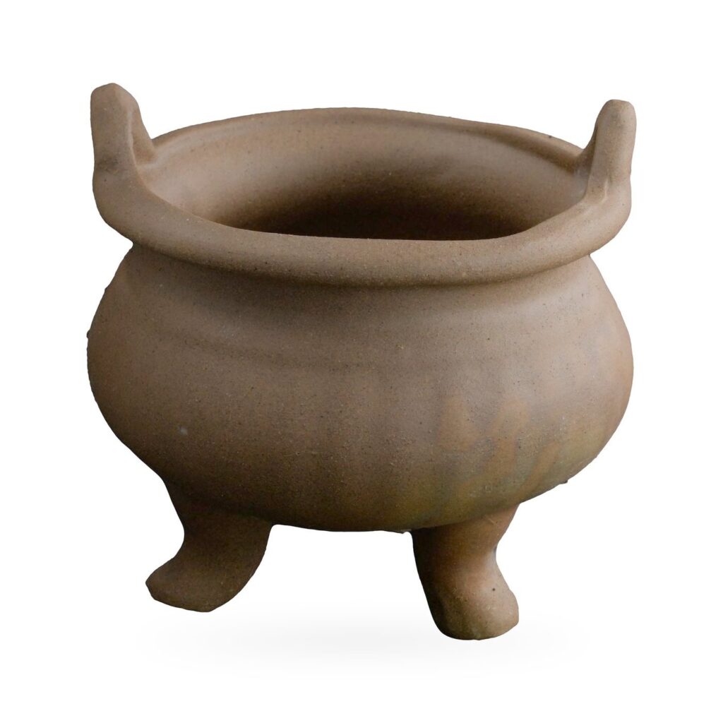 Brown clay cauldron-style succulent pot with a rounded belly, two upright ear handles and short legs