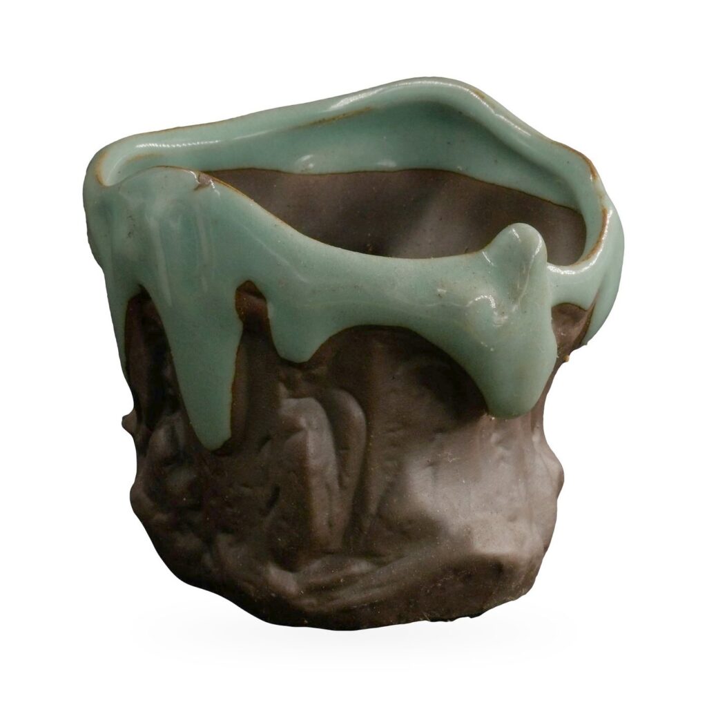 Freeform succulent pot with glossy jade-green drip glaze over a dark brown rock-textured body
